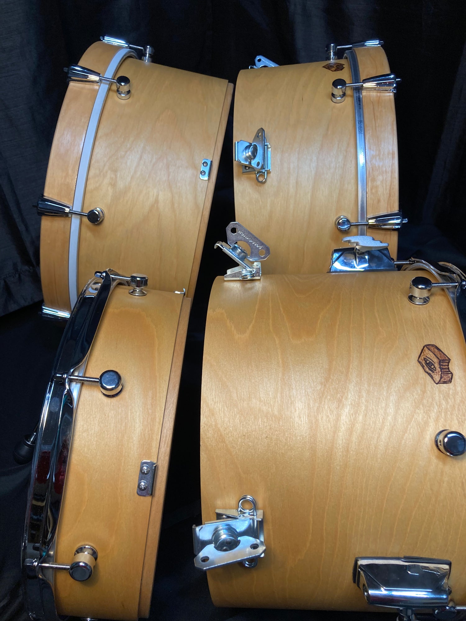 Brownie Nesting Drums showing the shells unlatched and separated in a natural birch finish