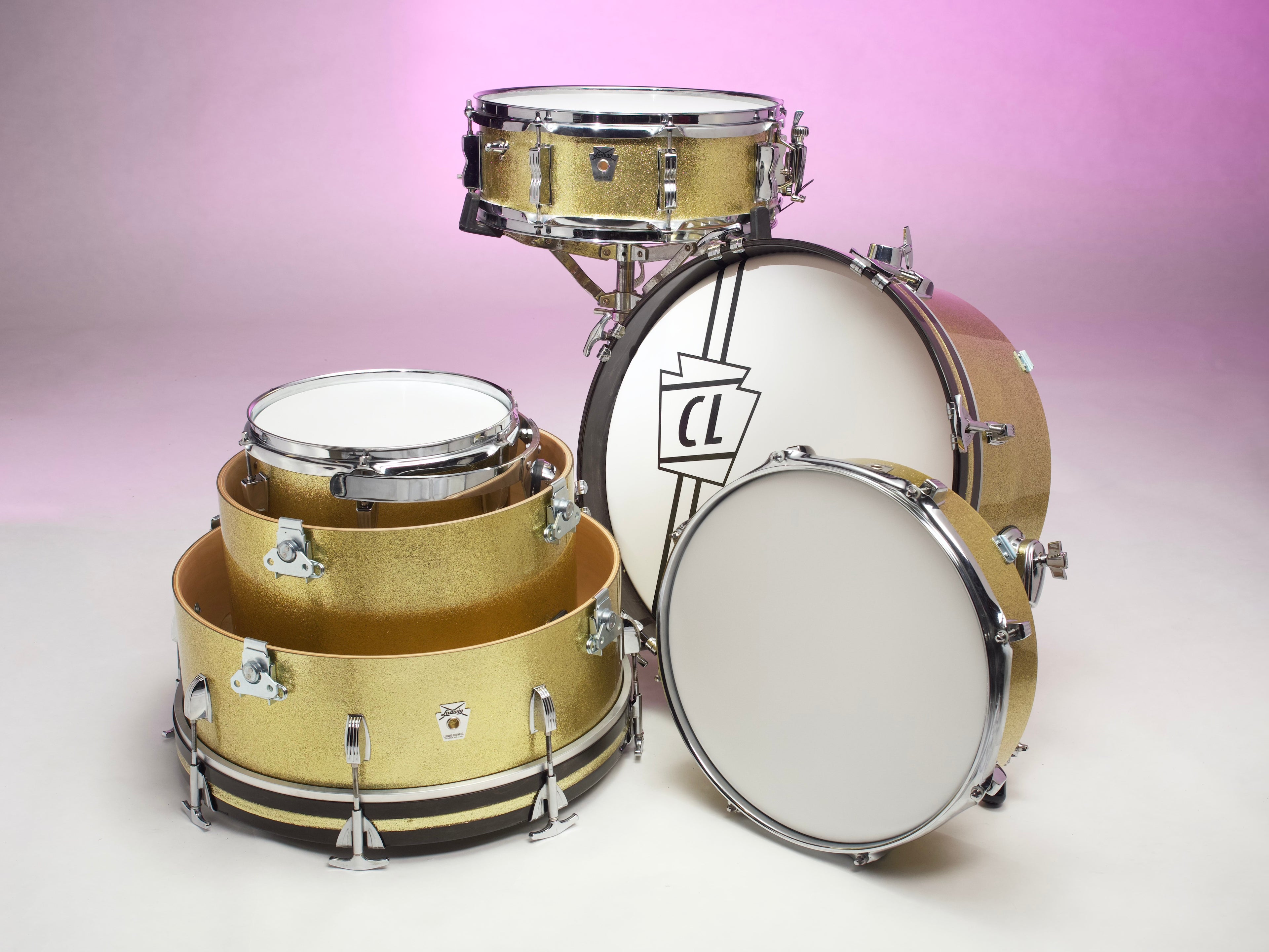 Drum set modified into a nesting drum set with latches for convenient portability 