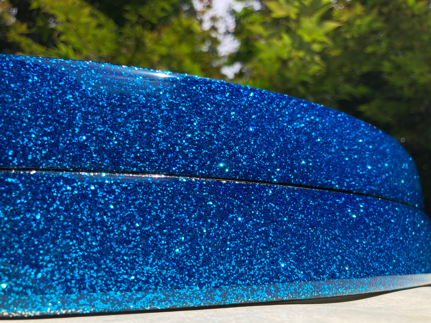 closeup view of a pair of blue sparkle bass drum hoops
