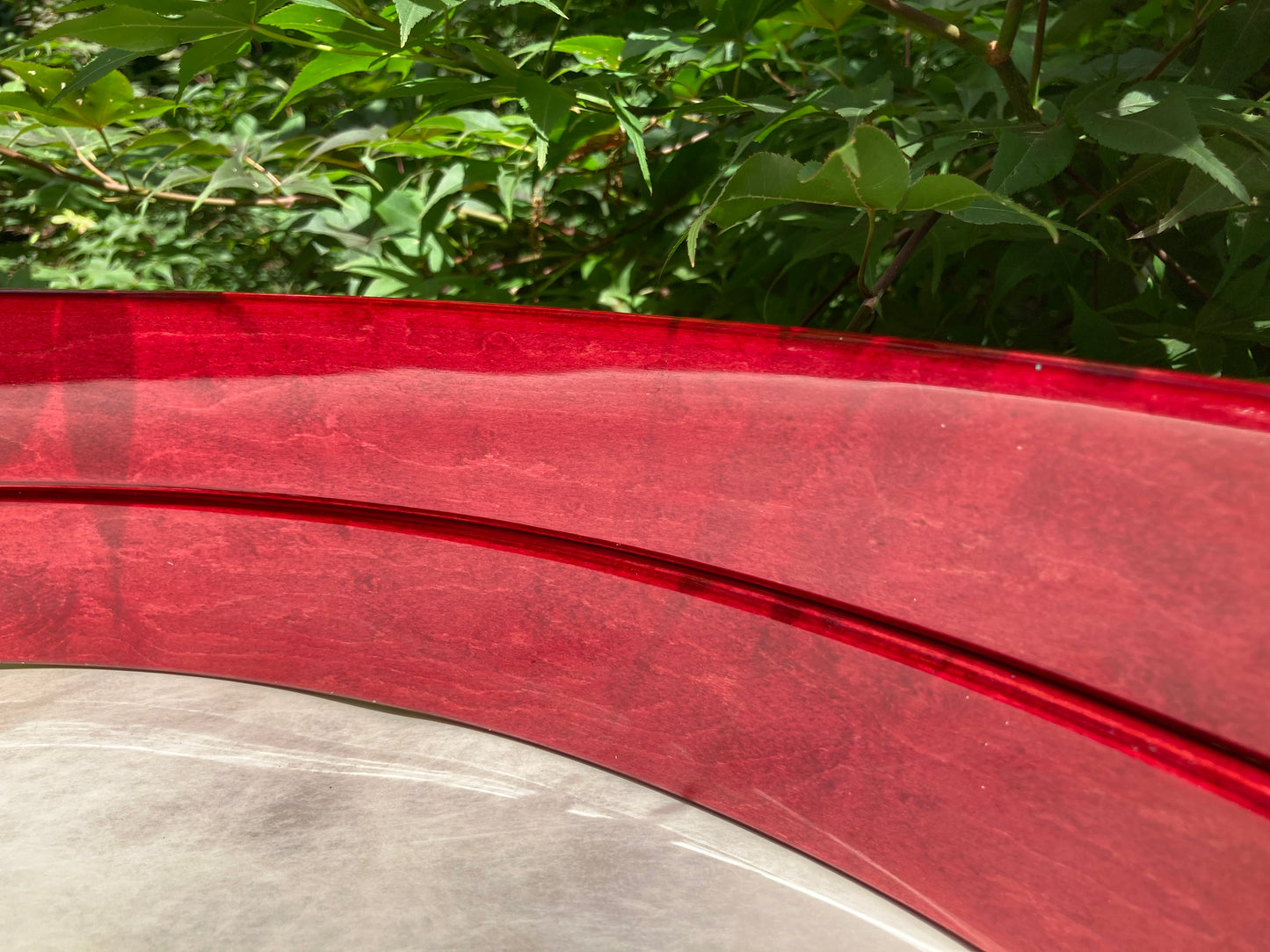 closeup of inner surface of a pair of bass drum hoops finished in red dye