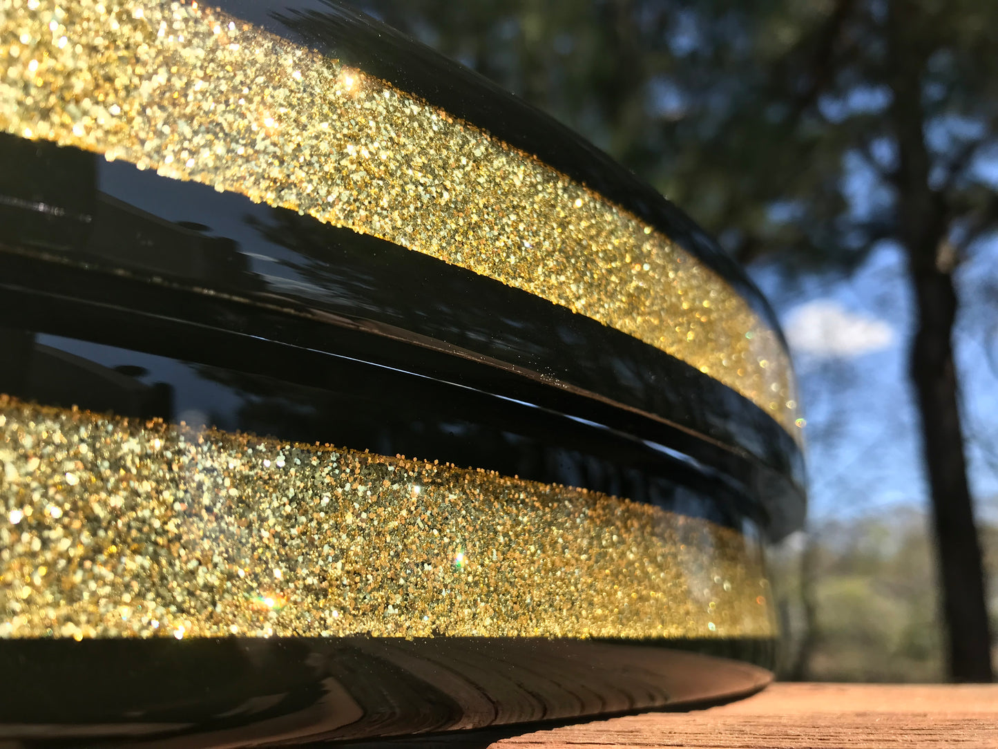 closeup of a pair of bass drum hoops with a gold sparkle inlay 