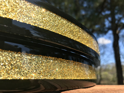 closeup of a pair of bass drum hoops with a gold sparkle inlay 