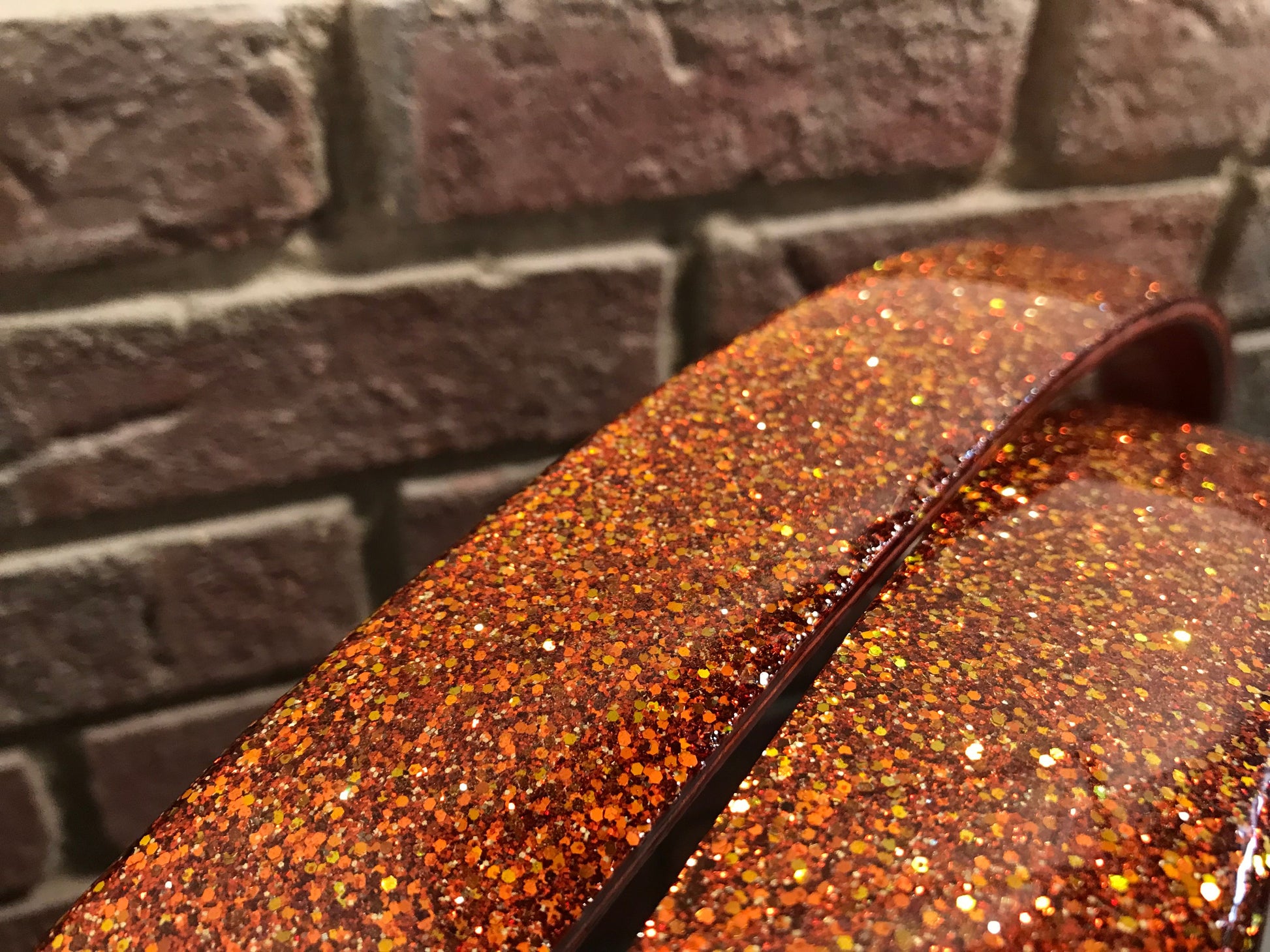 closeup view of a pair of bass drum hoops with a metal flake finish