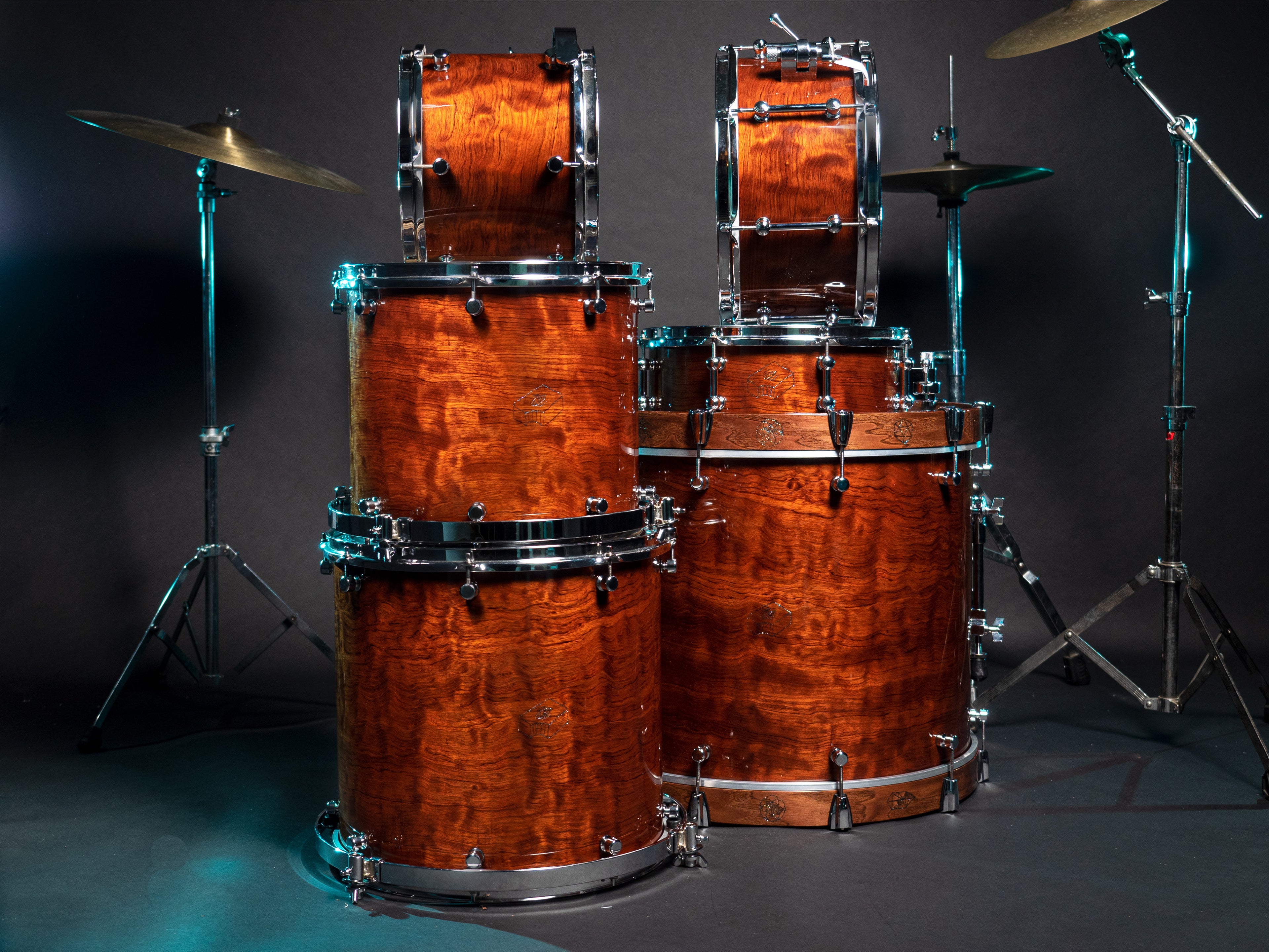 Hand made drum set stacked in two columns with cymbals on stands