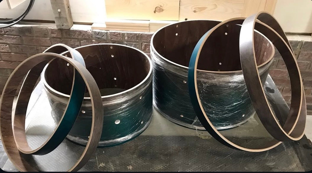 Two drum shells with a section cut to alter the shell depth
