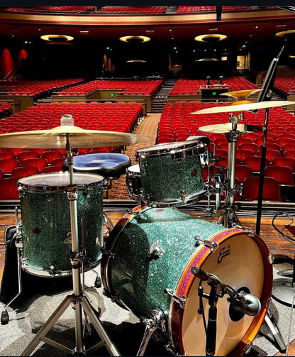 Brownie Drum Company nesting drum set set up on auditorium stage